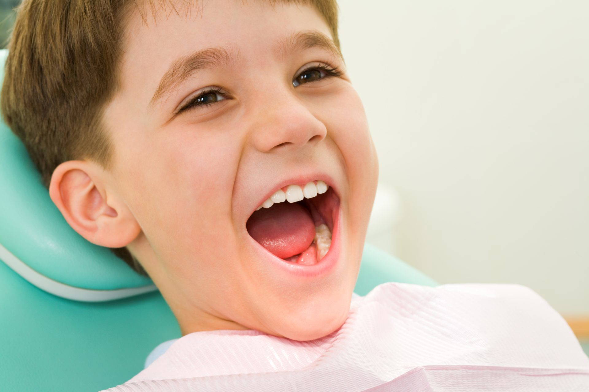 Photo of youngster with his mouth wide open during checkup at the dentist's