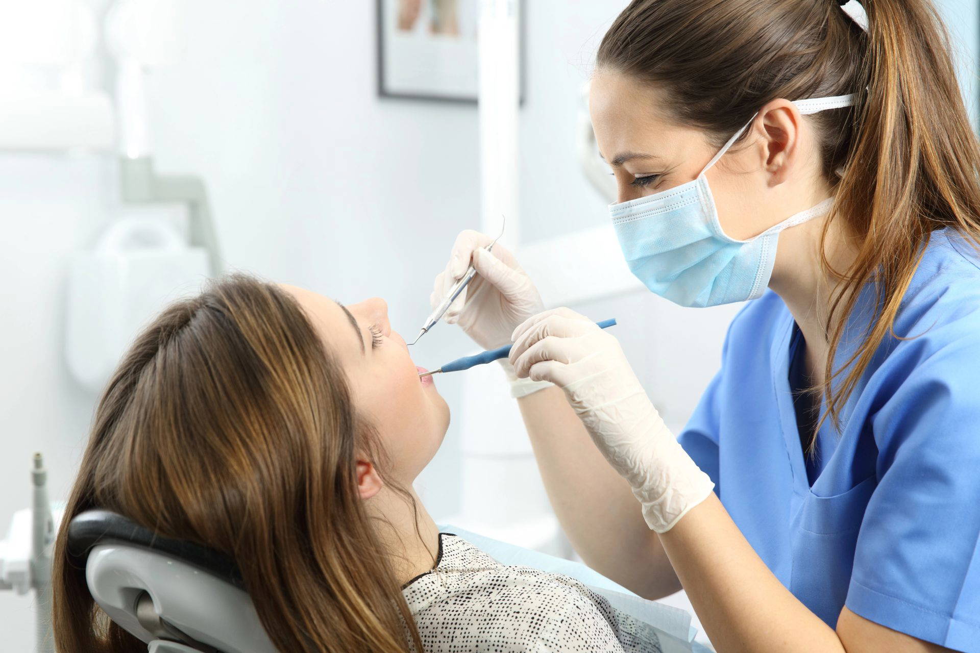 Specialist dentist treating a patient in a dental chair