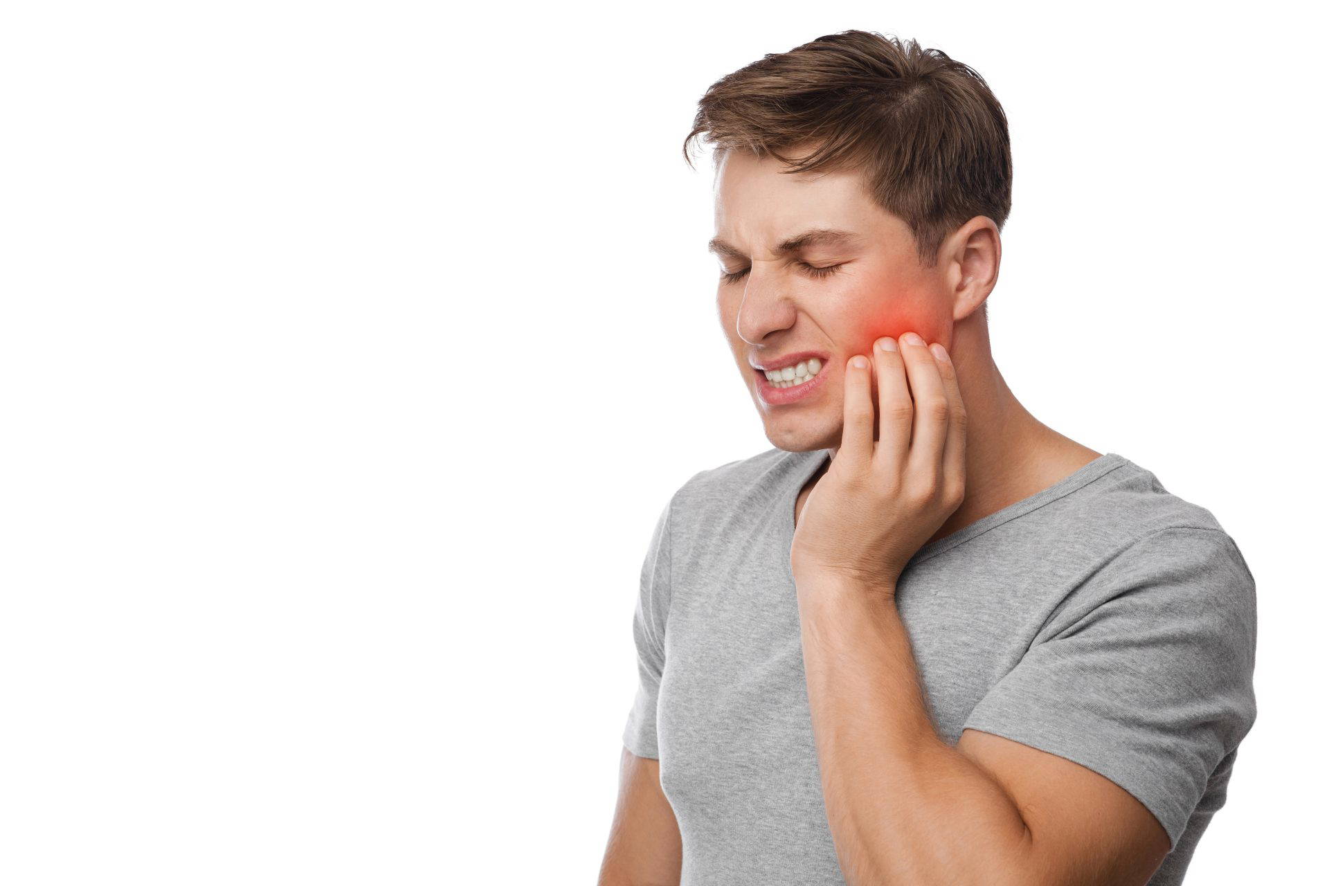 Patient holding their jaw in pain before a tooth extraction