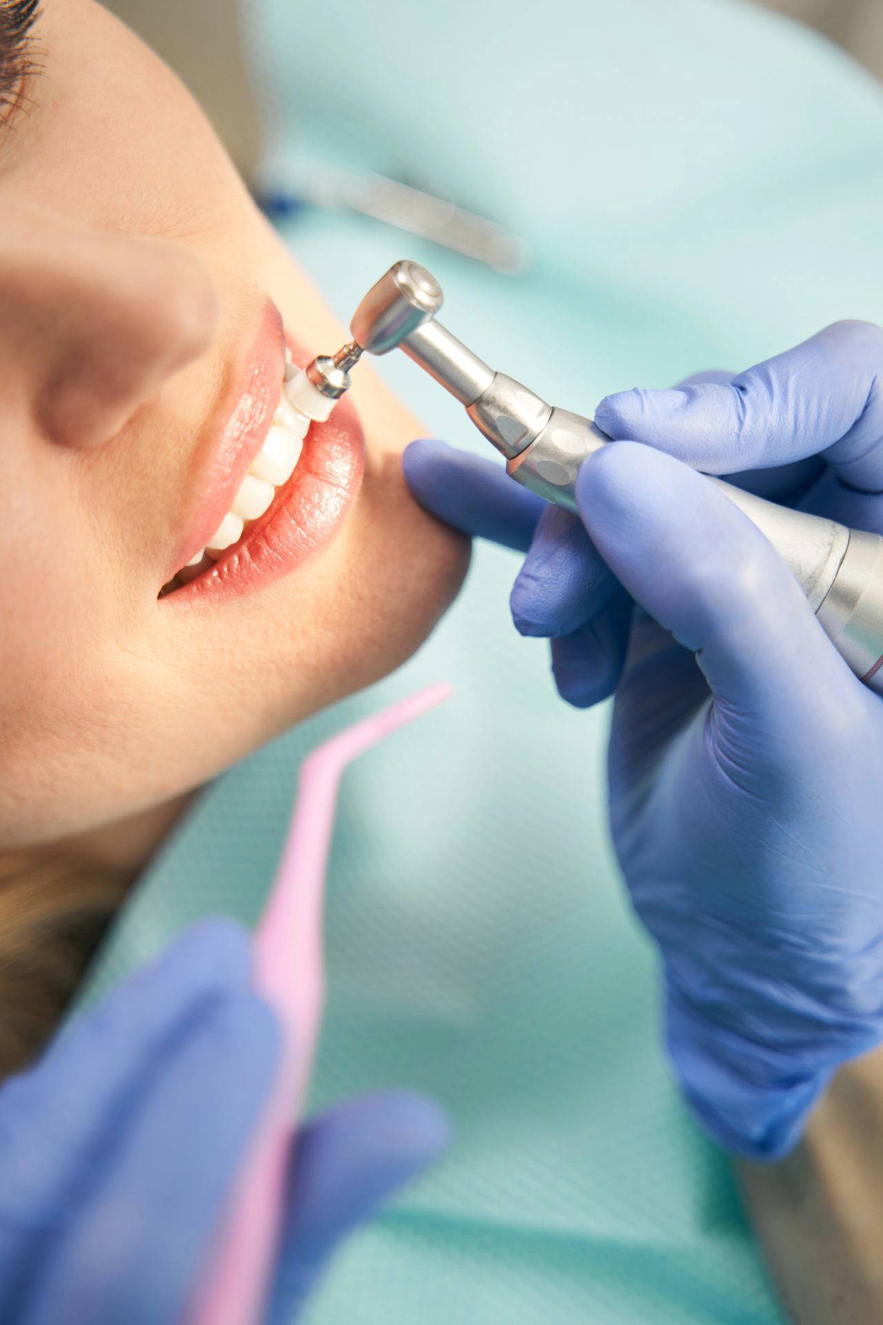 Dentist closely examining a patient's teeth during an examination
